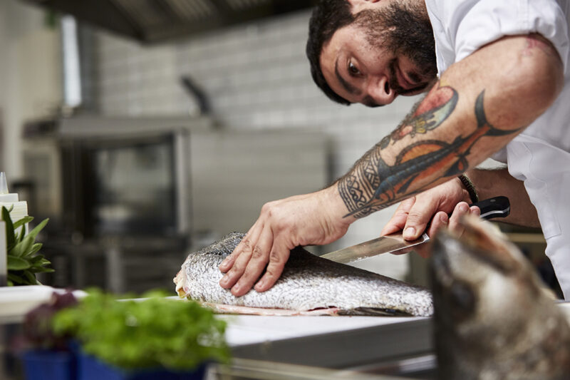 A chef preparing a fish
general food & beverage photos