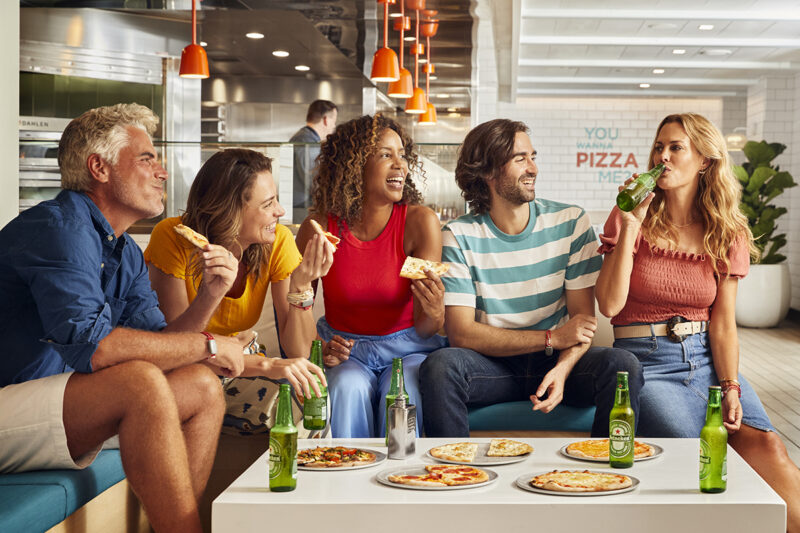 A group eats together at The Pizza Place onboard Scarlet Lady.  Photoshoot of Vitamin Sea activities by Melanie Acevedo onboard Scarlet Lady, Virgin Voyages
Photoshoot of Vitamin Sea activities by Melanie Acevedo onboard Scarlet Lady, Virgin Voyages
Vitamin Sea & Project Jackson Photoshoot Cabins onboard SCL  Shoot Date: Sept 18-25, 2021
Shoot Location: Transit from NY-Bimini  Usage: Worldwide/universal unlimited rights in perpetuity for all media including 3rd party usage (Virgin Brands) for all footage and images captured during the shoot. Excluding TV + Broadcast.
Talent Usage: 5 Years Worldwide/universal unlimited rights in perpetuity for all media including 3rd party usage for all footage and images captured during the shoot. Excluding TV + Broadcast. 
TEAM
Photographers:
Lifestyle: Melanie Acevedo
Cabins: Sang An
Agent: Kenna Zimmer, Sarah Laird & Good Company
https://sarahlaird.com  CD: Christian Schrader
Art Buyer / Producer: Kathy Boos