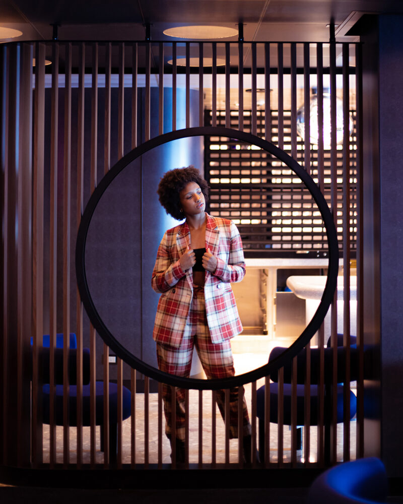 Woman wearing a plaid suit inside Pink Agave. @ginajoyphoto